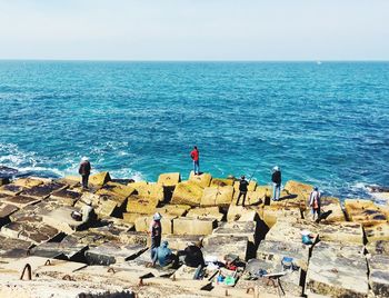 Panoramic shot of man standing by sea against clear sky