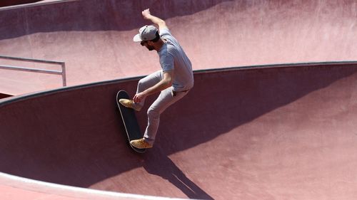 Young man skateboarding at skateboard park