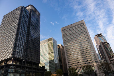 Low angle view of modern buildings against sky in city