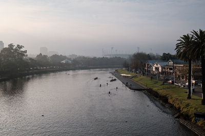 View of the yarra river in melbourne with the melbourne cricket ground in the background.
