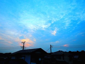 Low angle view of houses against sky during sunset