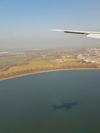 Aerial view of sea and landscape against sky