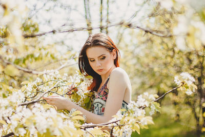 Portrait of beautiful woman with red flower