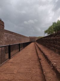 Pathway in fort against sky