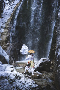 Scenic view of waterfall in forest during winter