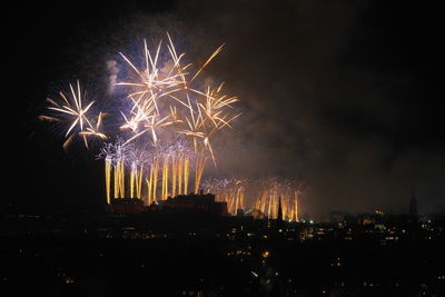 Low angle view of firework display at night