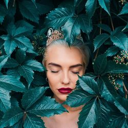 Portrait of woman with green leaves