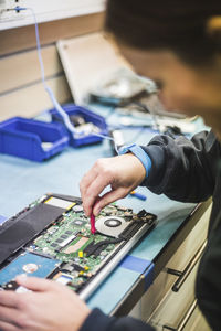 Technician repairing computer part in store