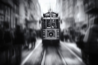 Blurred motion of train at railroad tracks in city