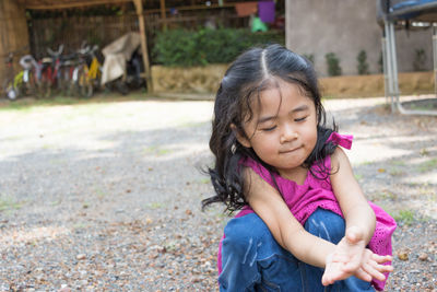 Girl crouching on field