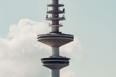 Low angle view of communications tower against sky