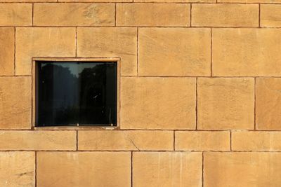 Full frame shot of brown wall with closed window