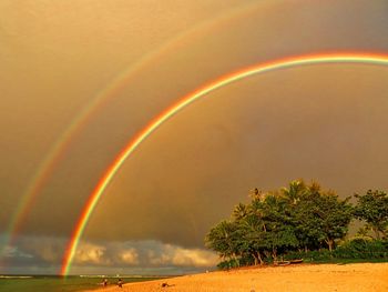 Scenic view of rainbow against sky during sunset