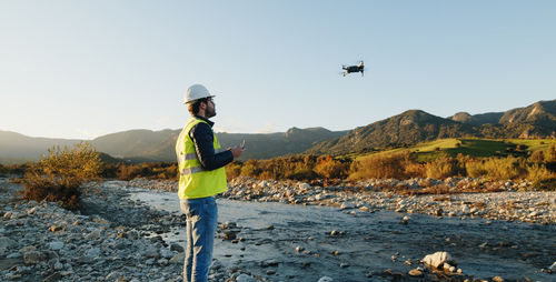 Boy with high visibility harness pilots drone safely