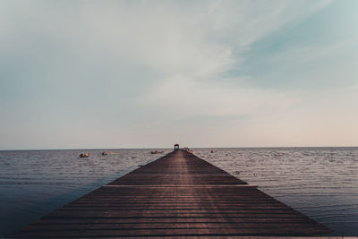 Pier over sea against sky