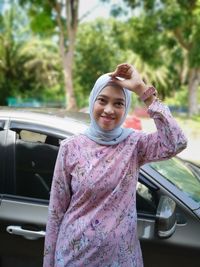 Portrait of a smiling young woman in car