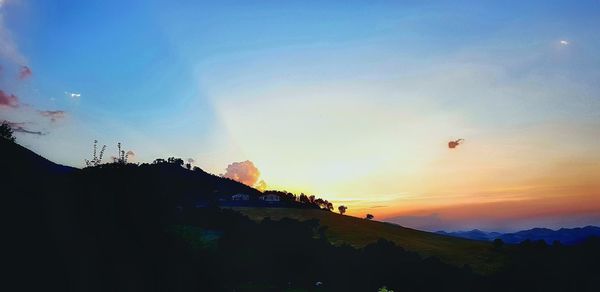 Scenic view of silhouette mountains against sky during sunset