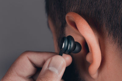 Close-up of man hand holding headphone