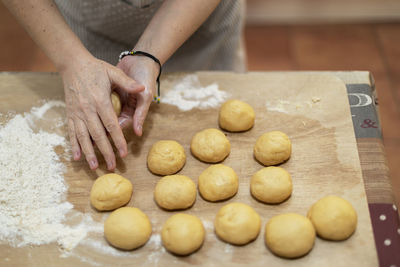 Close-up of woman preparing food on table