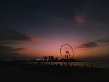 Silhouette pier over sea against sky during sunset