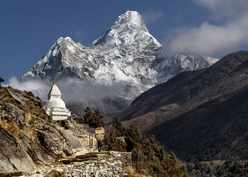 Nepal, khumbu,traveler walking towards stupa in himalayas