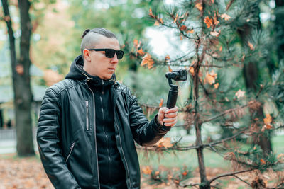 Young man standing in forest