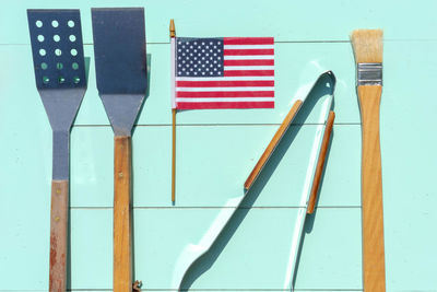 Directly above shot of cooking utensils with american flag on table