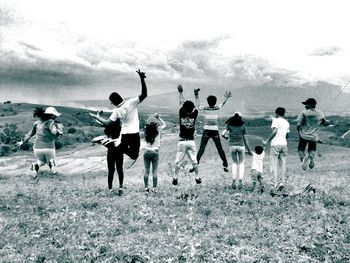 People playing on field against sky