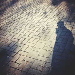 Shadow of people on footpath