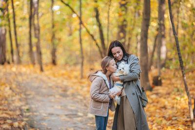 Couple kissing in forest during autumn