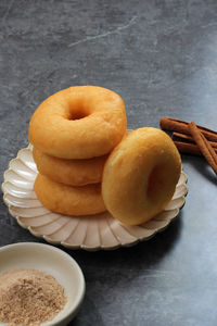 Homemade fresh fried donuts on grey table