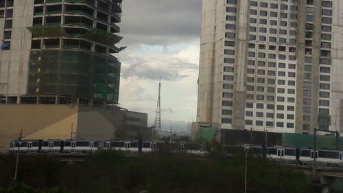 Buildings against cloudy sky