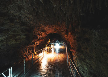 Illuminated tunnel seen through cave