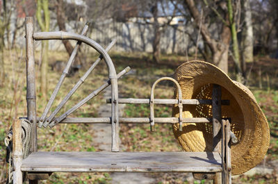 Close-up of old rusty wheel on field