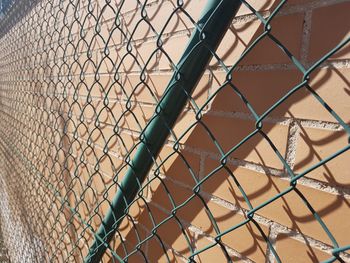 Green mesh, fence, shadows, shapes