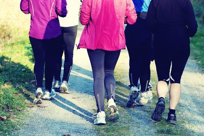 Low section of people walking on road