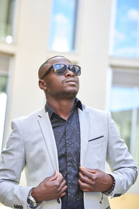 Stylish african american businessman posing with sunglasses.