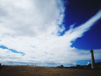 Low angle view of landscape against blue sky