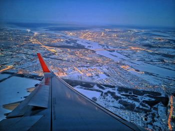 Aerial view of cityscape against sky during winter