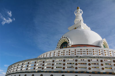 Low angle view of bell tower against blue sky