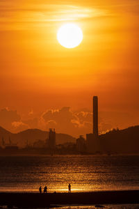 Scenic view of sea against orange sky during sunset