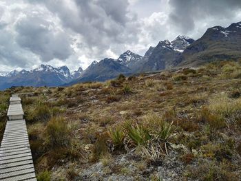 Scenic view of mountains against cloudy sky