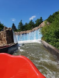 Scenic view of waterfall against sky