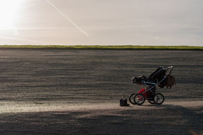 Horse cart on field against sky