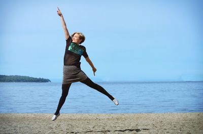 Full length of woman jumping in sea