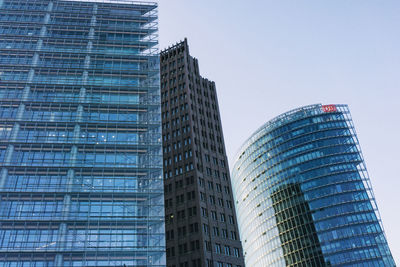 Low angle view of skyscrapers against clear sky