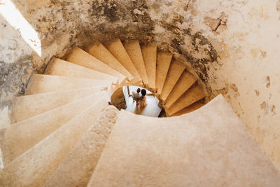 High angle view of people walking on spiral staircase
