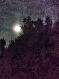 Low angle view of illuminated moon against sky at night