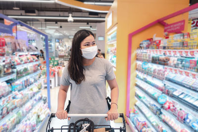 Woman wearing flu mask in store