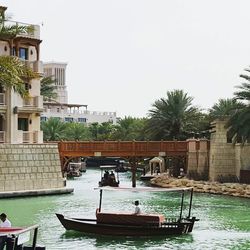 Boats in sea against clear sky